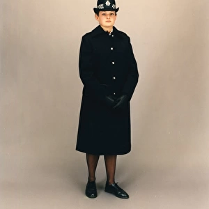 Woman police officer in coat and bowler hat, London