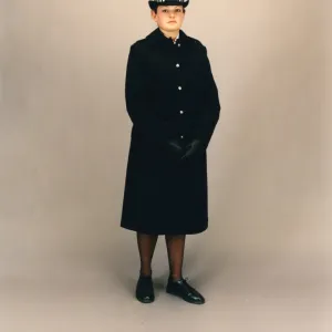 Woman police officer in coat and bowler hat, London