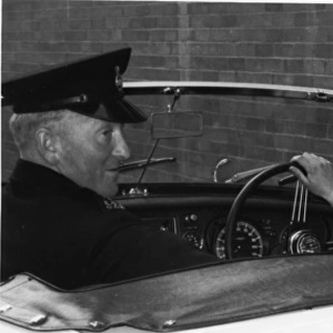 Woman police officer at the wheel of a car, London