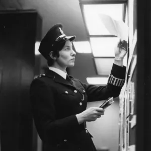 Woman police officer at work in a London police station