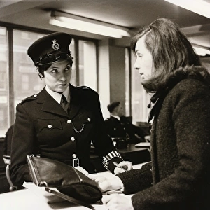 Woman police officer at work in a London police station