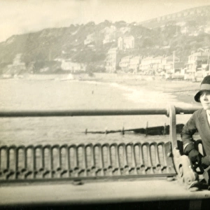 Woman sitting on a bench at the pier