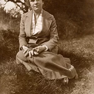 Woman sitting on grass in a field