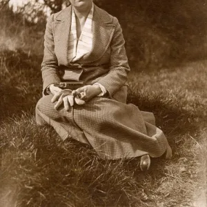 Woman sitting on grass in a field