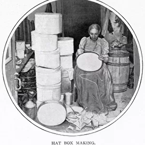 Woman sitting in her own home in South London, making the hat boxes for a supplier that