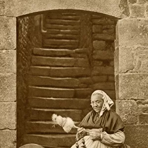 Woman at a spinning wheel, Dinan, Brittany, Northern France