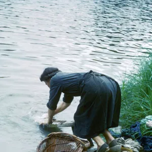 Woman washing clothes in a river