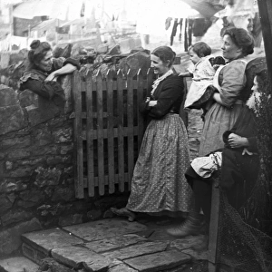 Women chatting in a back yard, Pontypool, South Wales