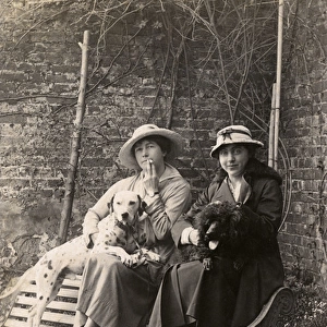 Two women and their dogs in a garden