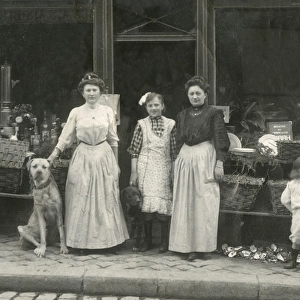Women and dogs outside a shop, France