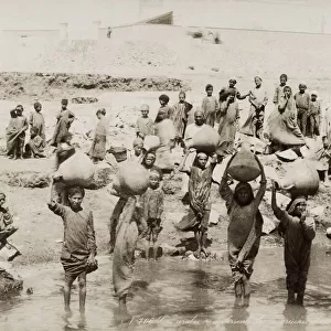 Women filling water pots from the River Nile, Egypt