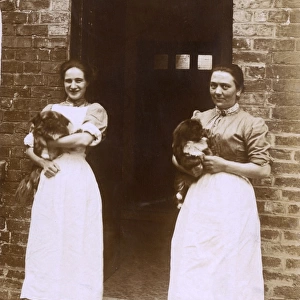 Two women with Pekingese dogs