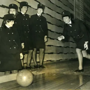 Women police officers at a bowling alley