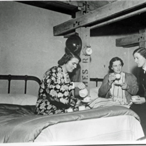 Three women police officers in a dormitory, London, WW2