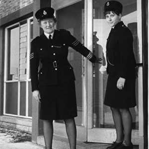 Two women police officers outside a police station