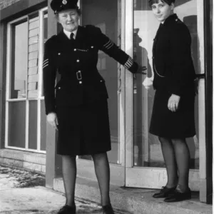 Two women police officers outside a police station