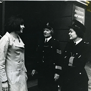 Two women police officers with woman on London street