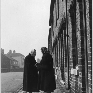 Two Women Talk in Street