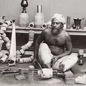 Wood turner working with a lathe, India
