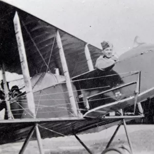 World War One pilot in his aircraft on an airfield