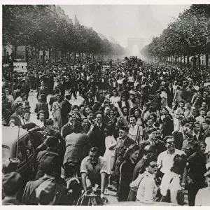WW2 - An enthusiastic crowd of celebrating Parisians fill the Champs Elysees until dawn