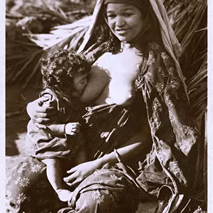 Young Algerian Mother breastfeeding her infant
