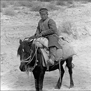 Young boy on a donkey, Kashgar, western China