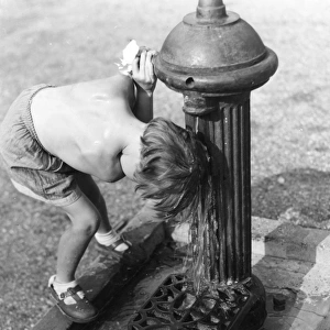 Young child with head under hydrant