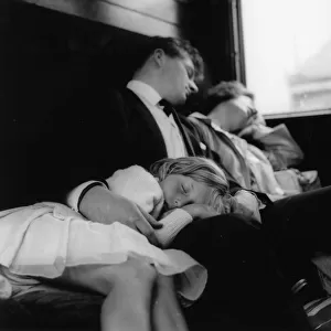 Young couple and child sleeping in a train compartment
