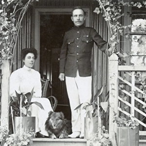 Young couple and a dog on a garden porch