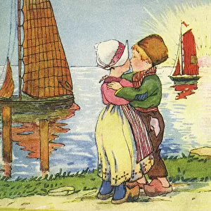 Young Dutch boy and girl share a kiss at sunset