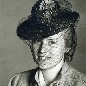 Young German Woman wearing a small black hat with a veil. Date: circa 1930s