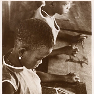 Young Ghanaian girl learning to draw