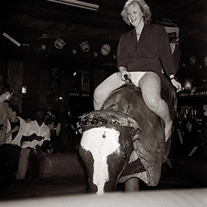 Young lady tries her hand at Bucking Bronco in Manchester pu
