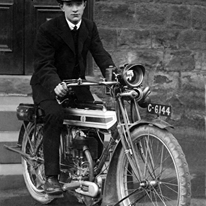 Young man on a 1910 / 14 Triumph motorcycle