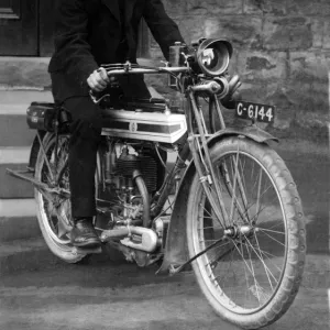 Young man on a 1910 / 14 Triumph motorcycle