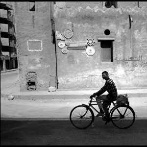 Young man on bike Cairo street, Egypt