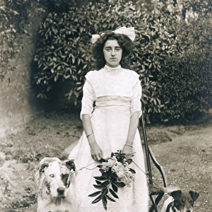 Young woman with two dogs in a garden