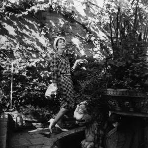 Young woman modelling a suit in a garden Young woman modelling a suit in a garden