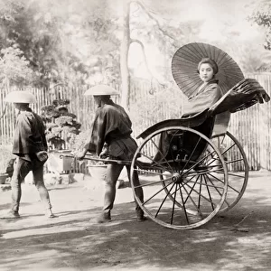 Young woman in a rickshaw, jinrikisha, Japan