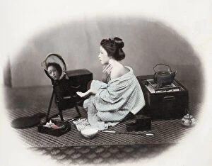 Aoriental Gallery: 1860s Japan - portrait of a young woman putting on make-up at a mirror Felice or Felix