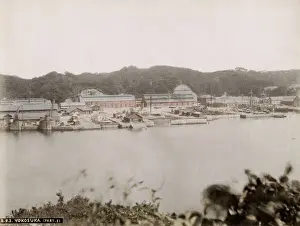 19th century vintage photograph: ships and boats in the dockyard at Yokosuka, Japan