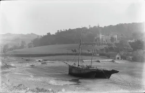 Riverbed Prints: Abandoned Boats by the Shore