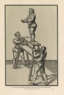 Acrobat Collection: Acrobat performing a backward somersault on two trestles