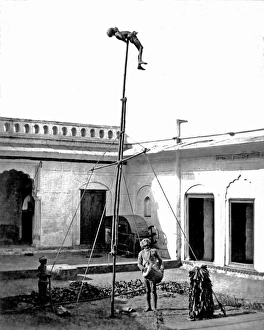 Drumming Collection: Acrobat on a pole, with drummer below, India
