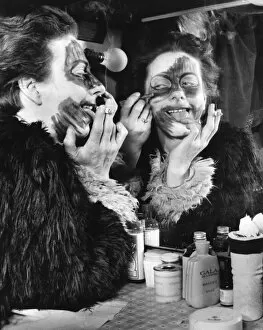 Actress Freda Wyn doing cat makeup for a pantomime