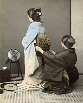 Adjusting Gallery: Adjusting an obi sash, Japan