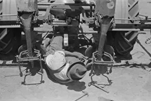 Adjusting plow points on tractor-drawn planter, large farm n
