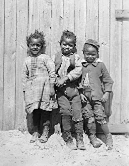 African American Gallery: Three African American children smiling together in America