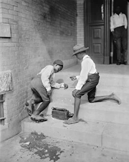 African American Gallery: Two African American shoe shine boys playing a gambling game